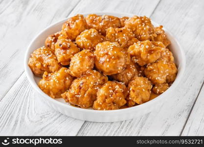 Bowl of orange chicken with sesame seeds