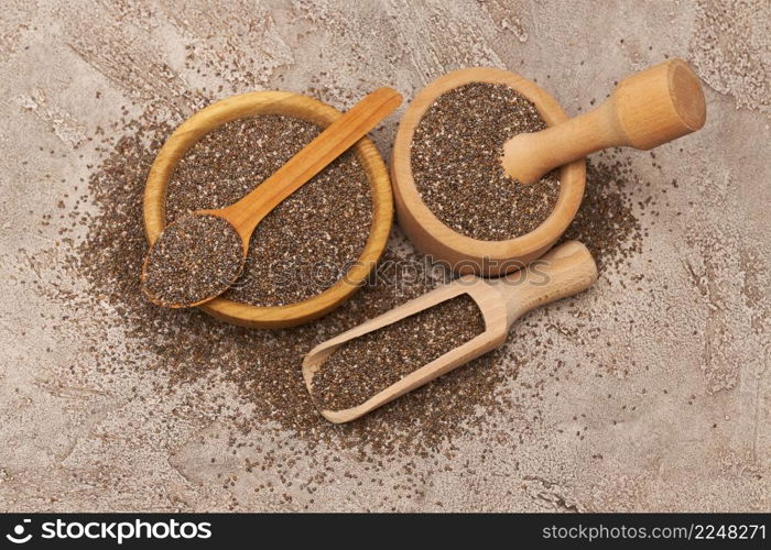 Bowl of organic natural chia seeds close-up on concrete background or table. High quality photo. Bowl of organic natural chia seeds close-up on concrete background or table