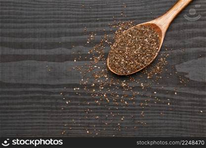 Bowl of organic natural chia seeds close-up on wooden background or table. High quality photo. Bowl of organic natural chia seeds close-up on wooden background or table