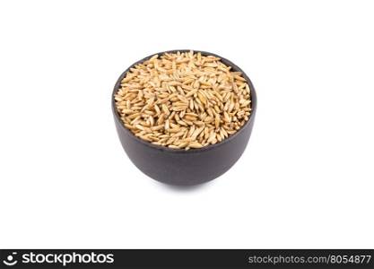 bowl of organic oat grains isolated on white background