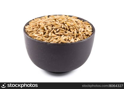 bowl of organic oat grains isolated on white background