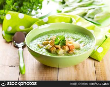 bowl of pea soup on wooden table