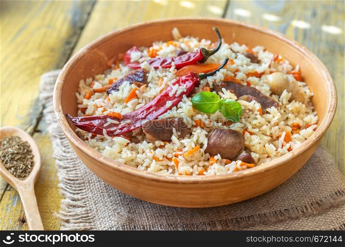 Bowl of pilaf on the wooden table