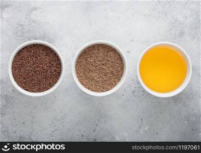 Bowl of raw natural organic linseed flax-seed with oil and powder on light background.
