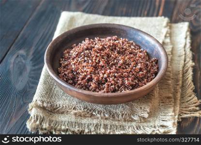 Bowl of red quinoa on the wooden background