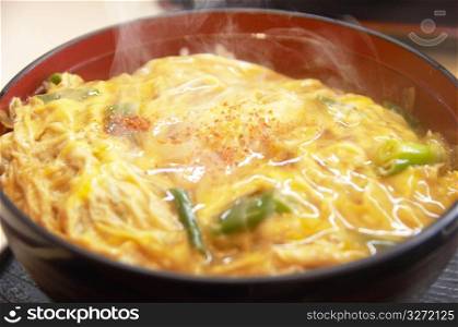 Bowl of rice topped with chicken and eggs