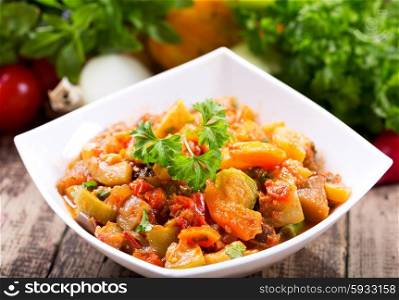 bowl of roasted vegetables on wooden table