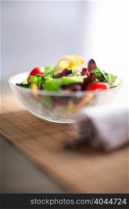 Bowl of salad on wooden board