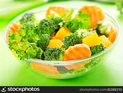 bowl of salad with broccoli, carrot, pumpkin and parsley