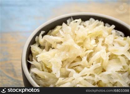bowl of sauerkraut on a grunge wood