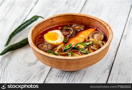 Bowl of spicy ramen with chili roasted salmon