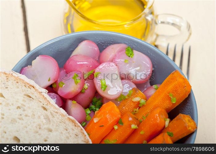 bowl of steamed root vegetable on a rustic white wood table