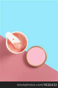 Bowl of strawberry ice cream on pink and blue background. From top view. Bowl of strawberry ice cream