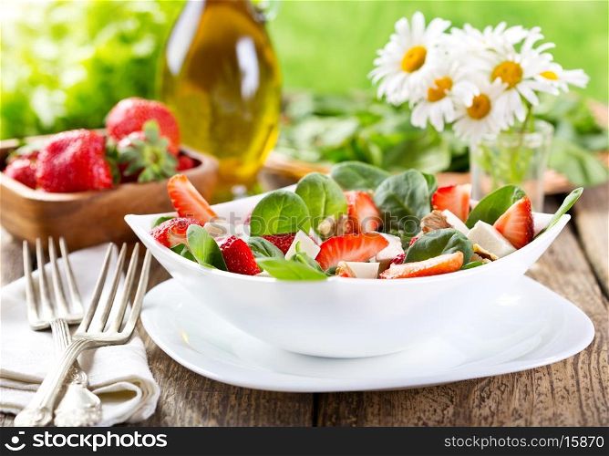 bowl of strawberry salad on wooden table