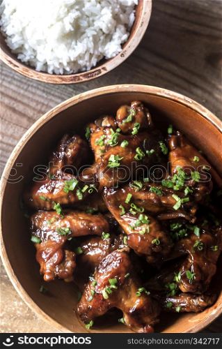 Bowl of teriyaki chicken wings with rice