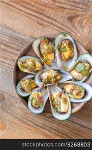 Bowl of Thai glazed half shell mussels 