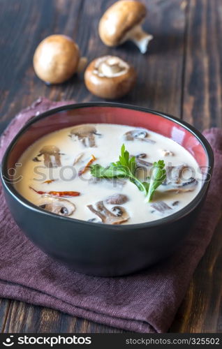 Bowl of thai tom kha soup on the wooden table