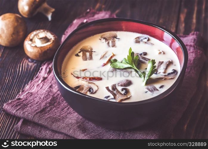 Bowl of thai tom kha soup on the wooden table