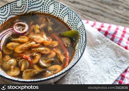 Bowl of thai tom yum soup on the wooden background