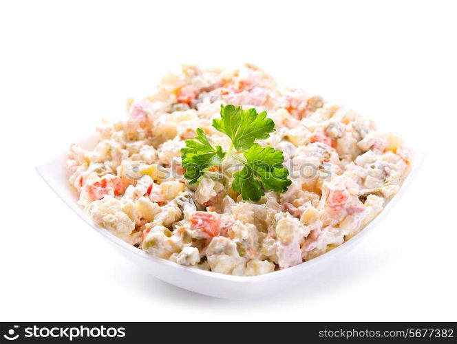 bowl of traditional russian salad on white background
