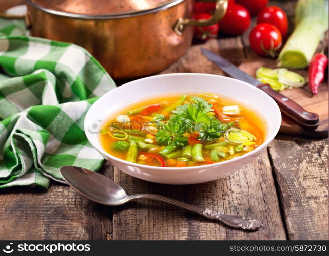 bowl of vegetable soup on wooden table