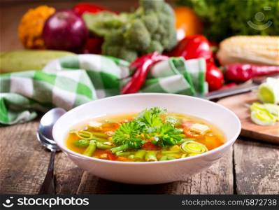 bowl of vegetable soup on wooden table