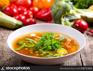 bowl of vegetable soup on wooden table
