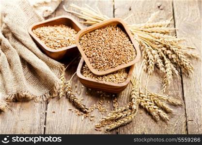 bowl of wheat grains on a wooden table