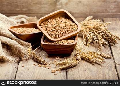bowl of wheat grains on a wooden table