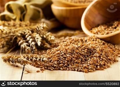 bowl of wheat grains on wooden table