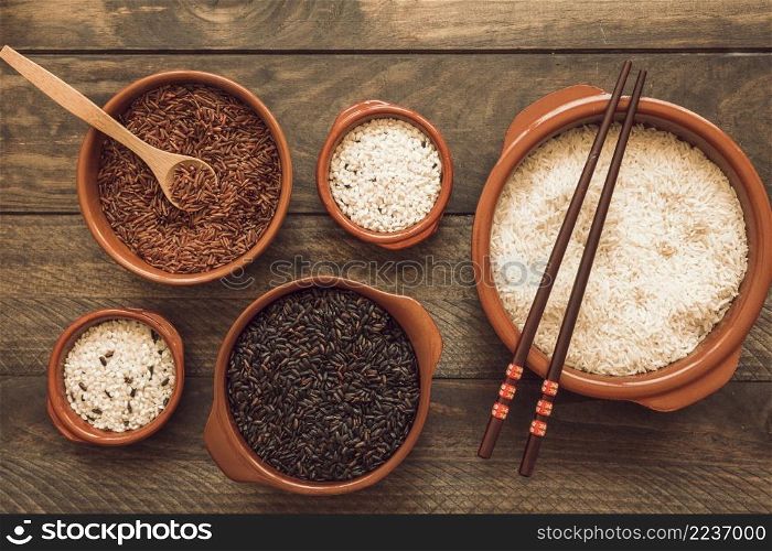 bowl red brown white rice with wooden spoon chopsticks