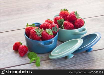 bowl s with fresh red strawberry on a kitchen table
