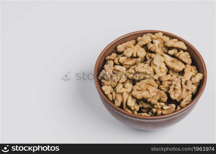 bowl walnuts white. High resolution photo. bowl walnuts white. High quality photo