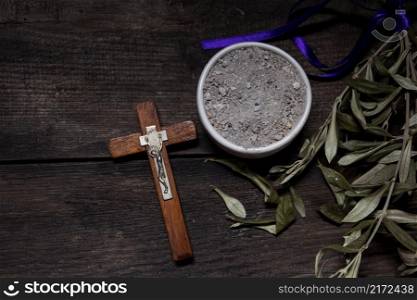 Bowl with ashes, olive branch and cross, symbols of Ash Wednesday. bowl with ashes and olive branch. ash wednesday concept