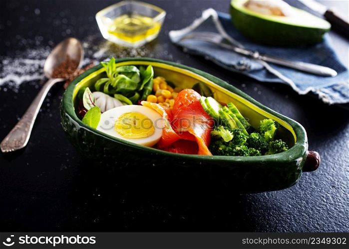 bowl with avocado, salmon, couscous and poached egg