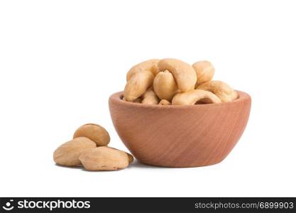 Bowl with cashews on a white background.. wooden bowl with cashews on a white background.