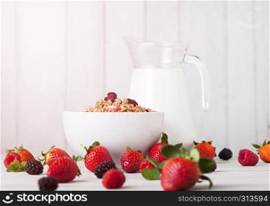 Bowl with cereal and fresh berries and jar of milk.Healthy summer breakfast