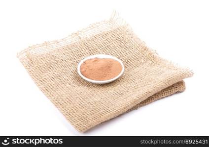 Bowl with cocoa powder on jute