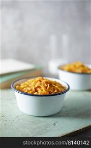 Bowl with cornflakes on background. 