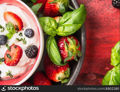 Bowl with cottage cheese, blackberries, blueberries, strawberries and basil ,top view close up