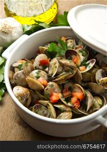 bowl with delicoius clams soup on wooden table