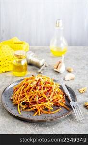 Bowl with fresh grated carrot on a table