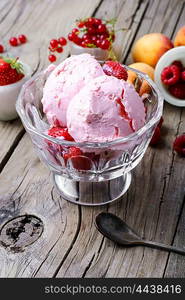 Bowl with fruit ice cream. Ice cream with berries currants and strawberries on wooden background