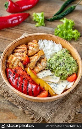 Bowl with grilled chicken, rice, blue cheese and vegetables