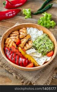 Bowl with grilled chicken, rice, blue cheese and vegetables