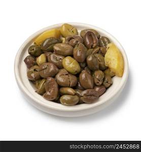 Bowl with hand pitted traditional Moroccan olives with herbs and lemon close up isolated on white background