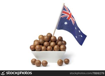 Bowl with macadamia nuts and the australian flag on white background