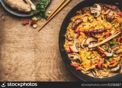 Bowl with noodles or pasta with vegetarian creamy sauce on rustic wooden background, top view, place for text. Healthy eating and cooking, clean or diet food concept