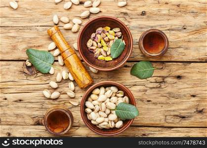 Bowl with pistachios on old wooden table.Nut. Pistachios nuts on wooden table