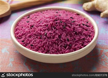 Bowl with red organic uncooked indian rice